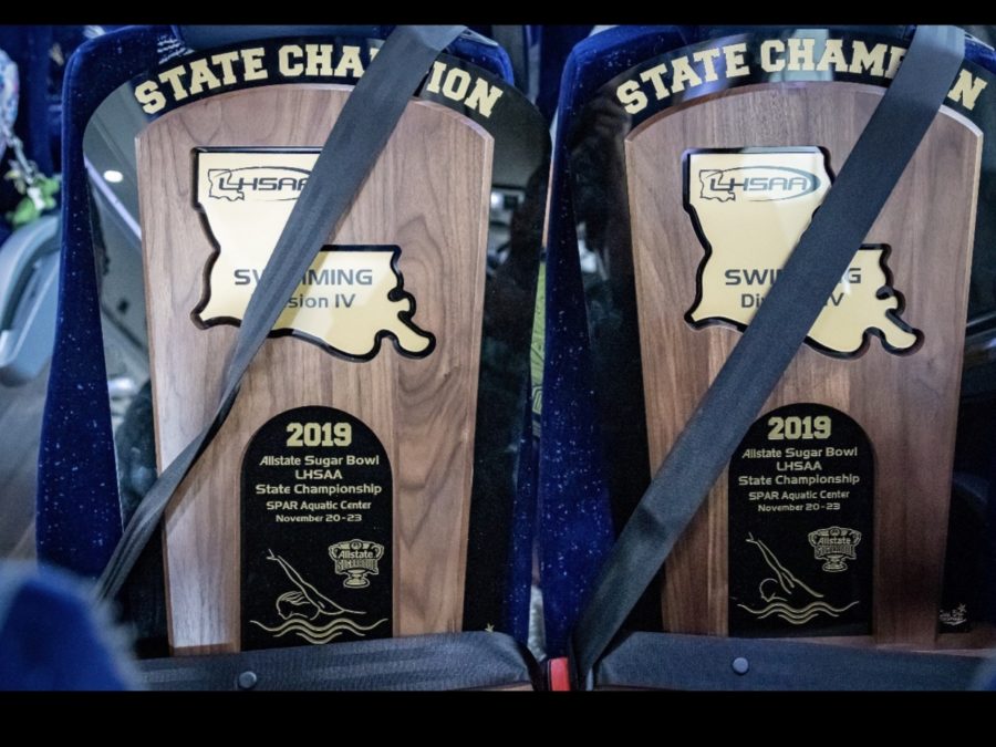 Safety First! Newman Swim Team secures the 99th and 100th state championships