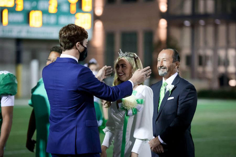 Newman Senior Class President Will Gottsegen crowns the 2020 Homecoming Queen Lucy Lynch